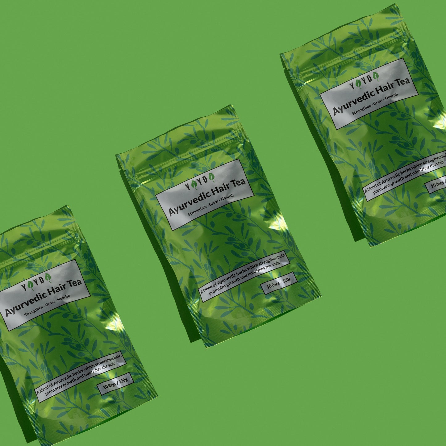 Three green hair tea bags on green studio background
