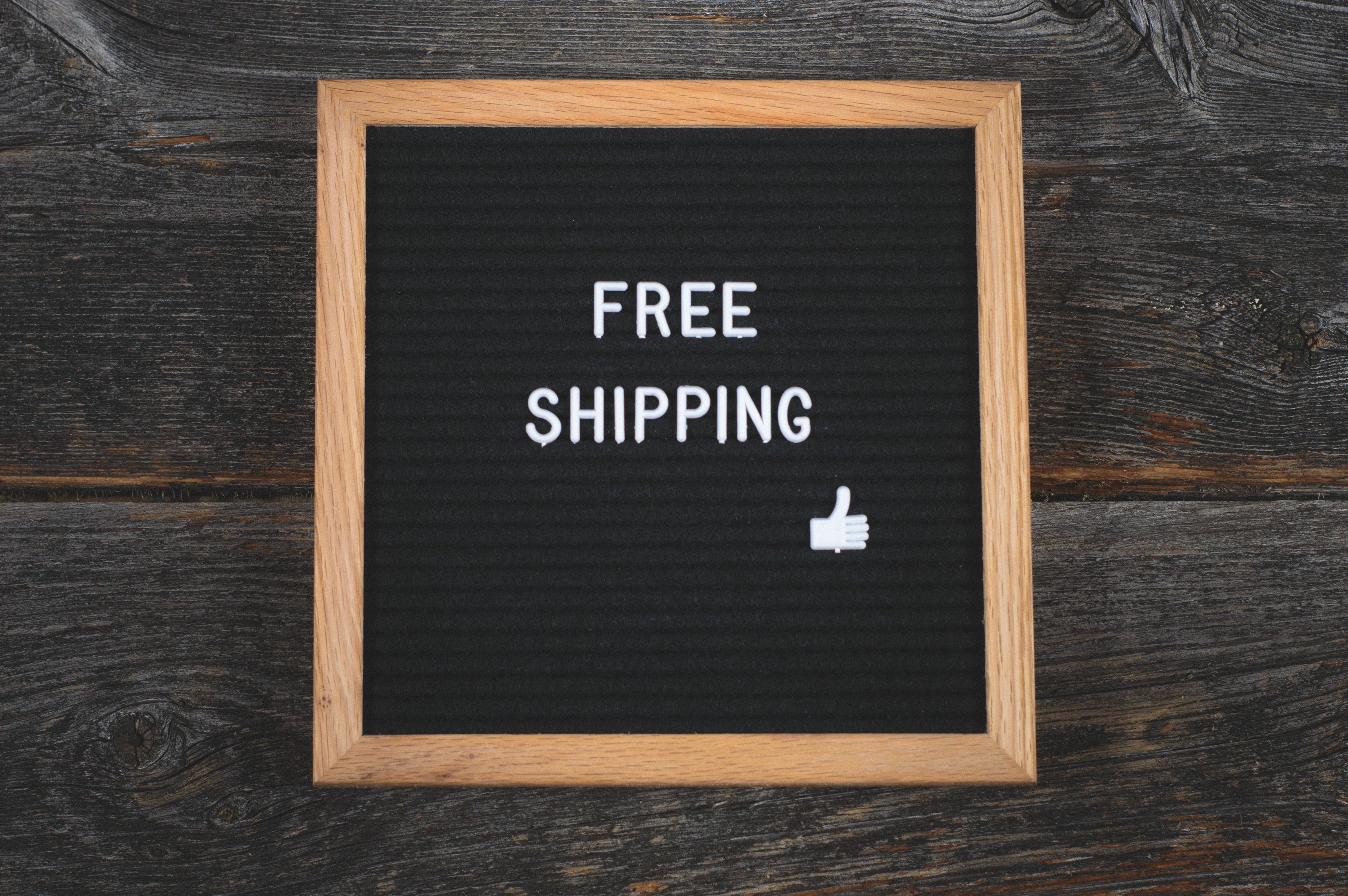 Wooden sign that says free shipping