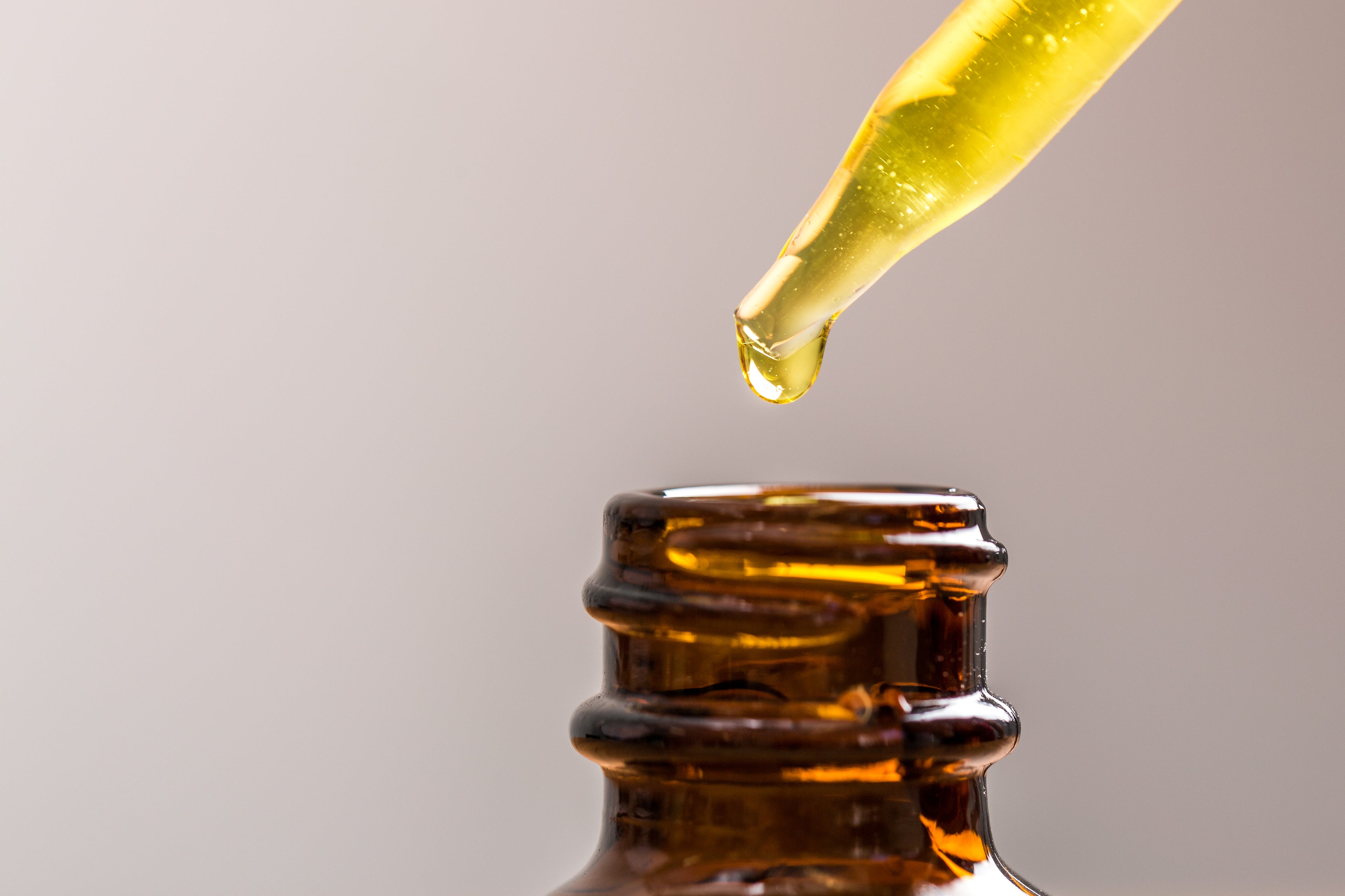 Pipette dripping oil into jar