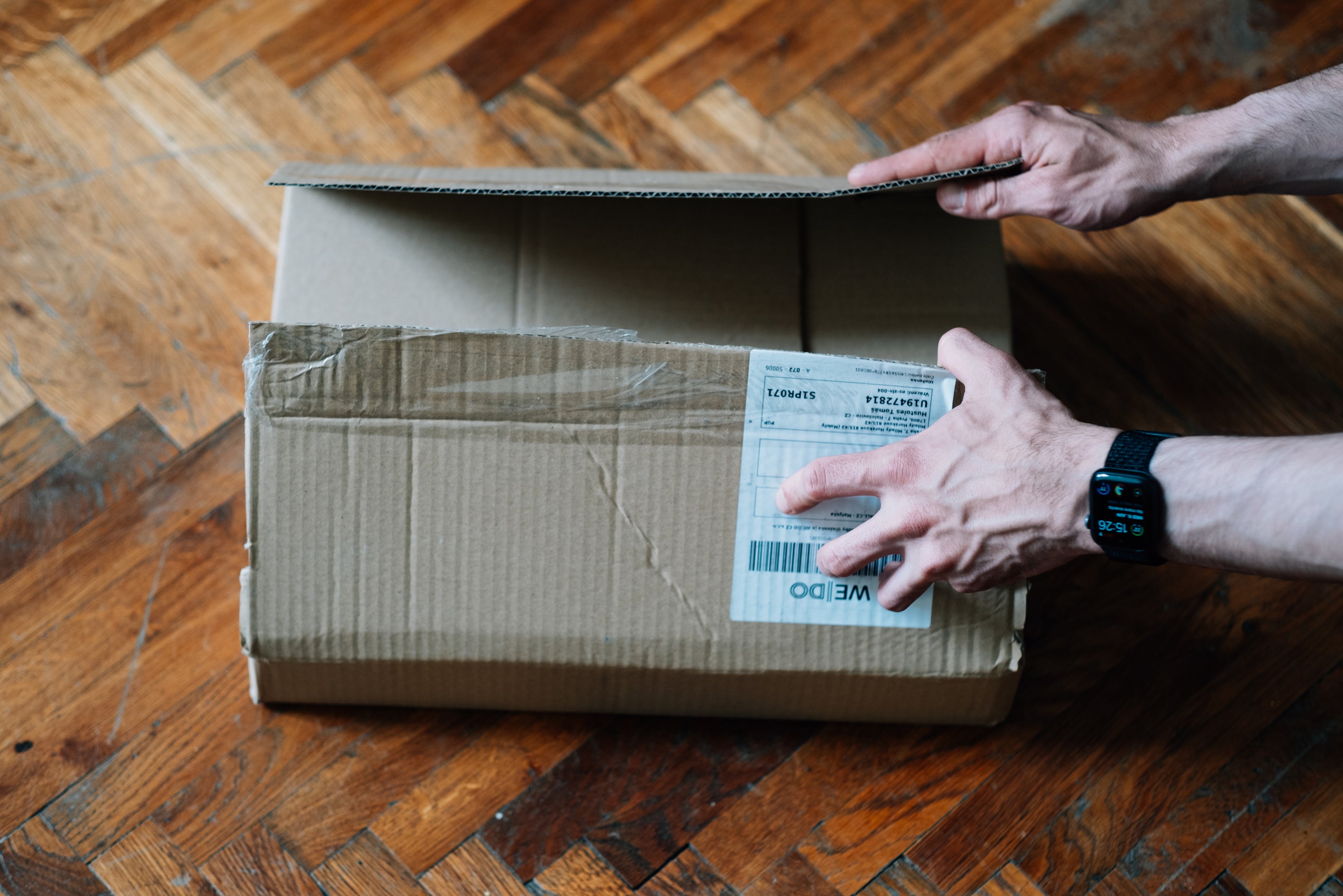 View of hands opening a package